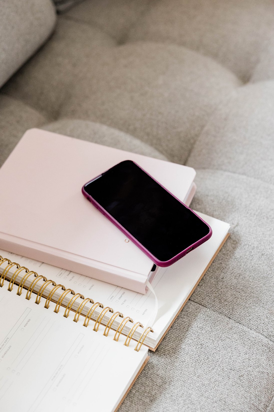 Phone and Notebooks on Couch